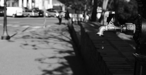 Close-up of bicycle on footpath in city