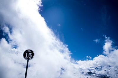 Low angle view of street light against cloudy sky