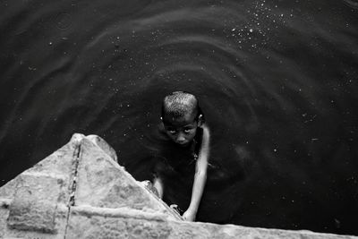 High angle view of boy in lake