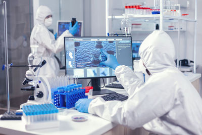 Midsection of scientist working in laboratory