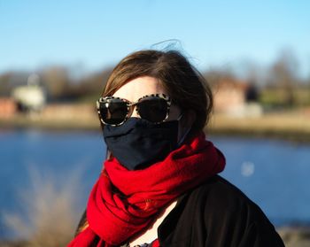 Portrait of a lady in a red scarf and covid mask
