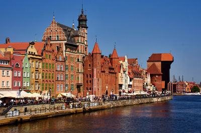 View of buildings in city against clear sky