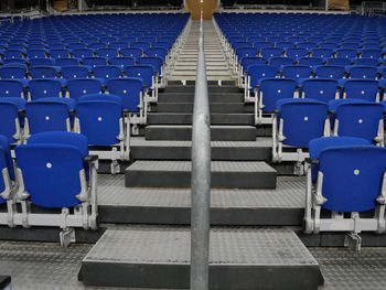 Empty blue chairs at stadium