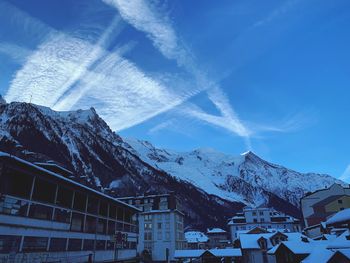 Scenic view of snowcapped mountains against blue sky