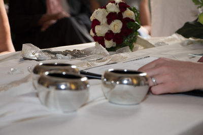 Midsection of woman holding ice cream on table