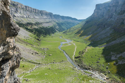 Scenic view of land and mountains against sky