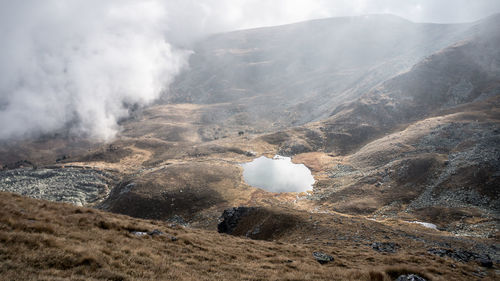 Smoke emitting from volcanic mountain