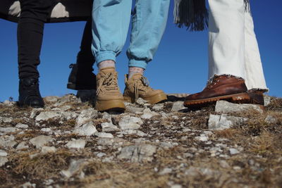 Low section of people standing on land