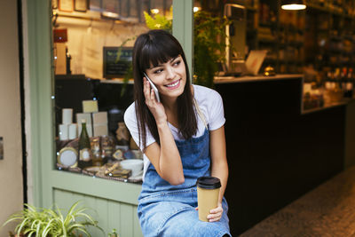 Portrait of a smiling young woman holding food