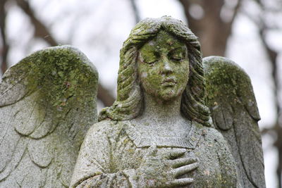 Close-up of statue against stone wall