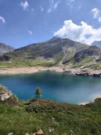 Scenic view of lake and mountains against sky