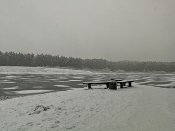 Scenic view of snowcapped field against clear sky