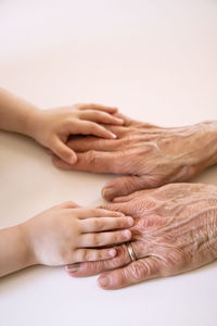 High angle view of cropped hands on table