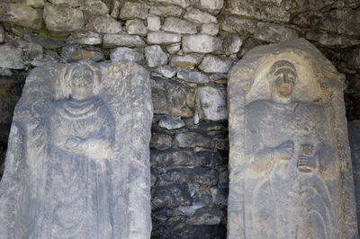 View of cross against stone wall