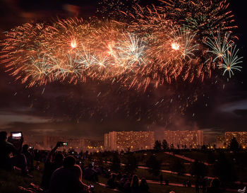 Low angle view of firework display at night