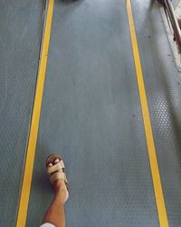 Low section of person standing on tiled floor