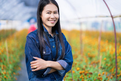 Portrait of smiling young woman standing outdoors