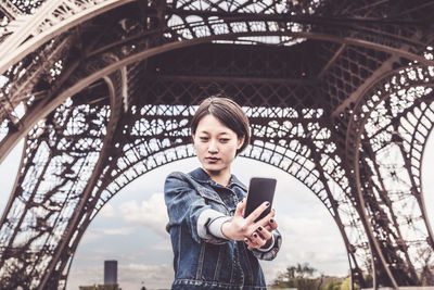 Portrait of young woman using mobile phone
