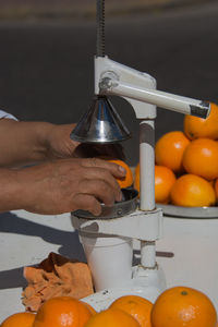Cropped hands preparing juice