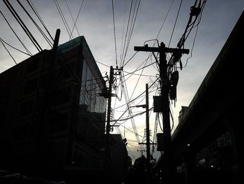 Low angle view of electricity pylon against sky