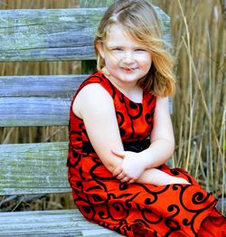 Portrait of girl sitting on bench