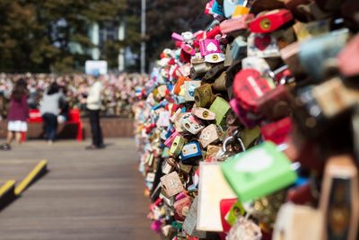 Colorful padlocks hanging on bridge