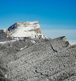 Low angle view of mountain against blue sky