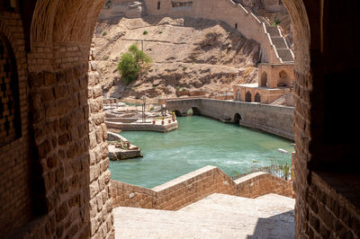 Shushtar historical hydraulic system with old houses constructions around, 