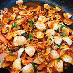 High angle view of clams and shrimps in cooking pan