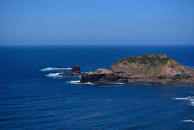 Scenic view of sea against clear blue sky