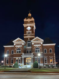 Low angle view of illuminated building against sky at night