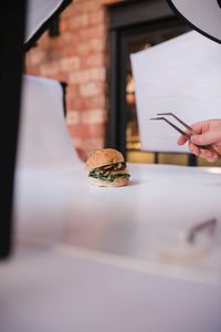 Person holding ice cream on table