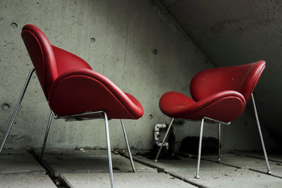 Empty chair against wall