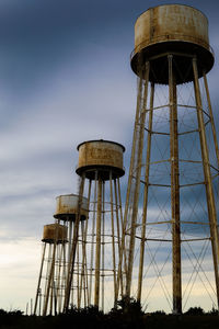 Water towers at sunflower ammunition plant before a storm