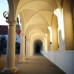 Empty arched corridor of building