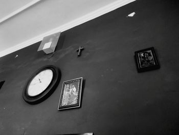 Low angle view of clock on wall