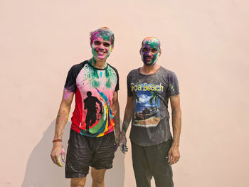 Portrait of happy indian men celebrating holi with powder colours or gulal. indian festival holi.