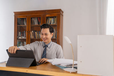 Young woman using laptop at home