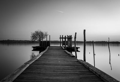 Pier over lake against sky