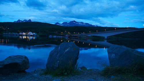 Panoramic view of lake and mountains against blue sky