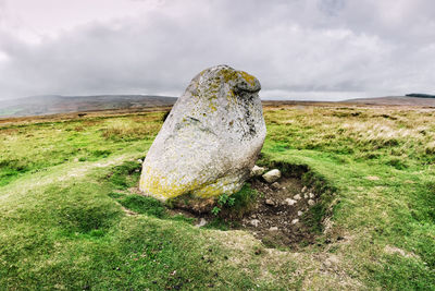 View of rock on land against sky