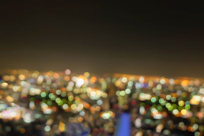 Defocused image of illuminated city at night