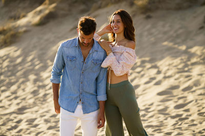 Young couple standing on beach