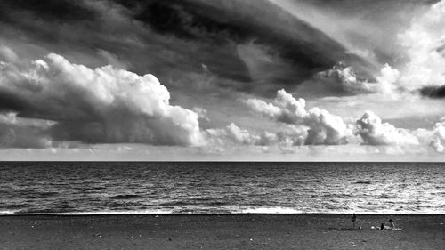 Scenic view of sea against cloudy sky