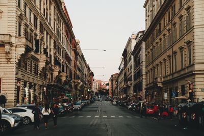 Street amidst buildings against sky in city