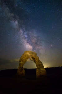 Scenic view of rock formation against sky at night