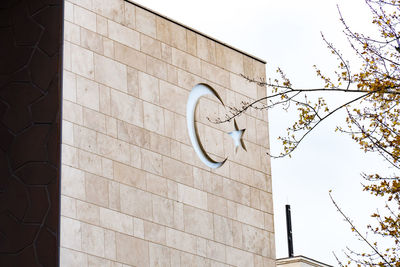 Low angle view of street light against building