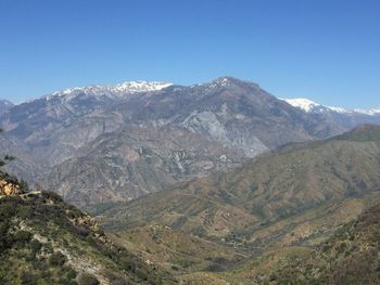 Scenic view of mountains against clear blue sky
