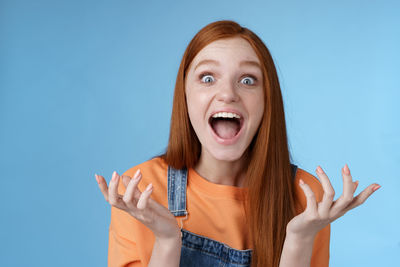 Young woman against blue background