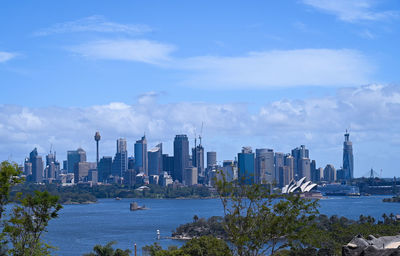 View of buildings in sea against cloudy sky